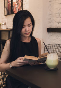 Close-up of a woman holding drink