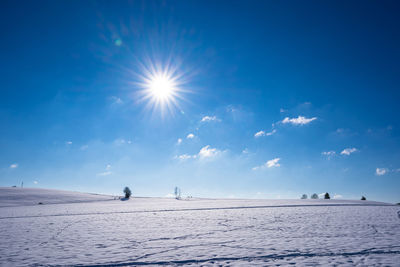 Scenic view of sea against bright sun