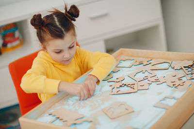 Boy drawing on table