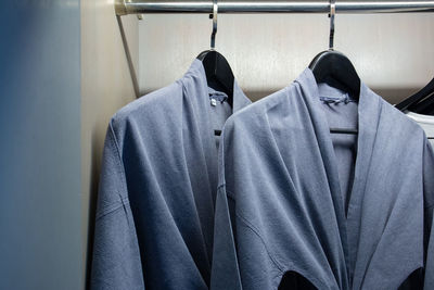 Close-up of clothes hanging on rack in shelf