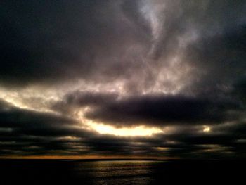 Scenic view of dramatic sky over sea during sunset