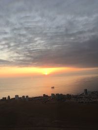 Scenic view of silhouette buildings against sky during sunset