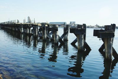 Wooden posts in sea