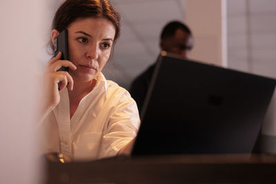 Young woman using laptop at table