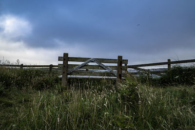 Fence on field against sky