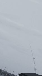 Low angle view of crane against sky