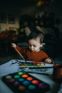 Portrait of boy playing at table