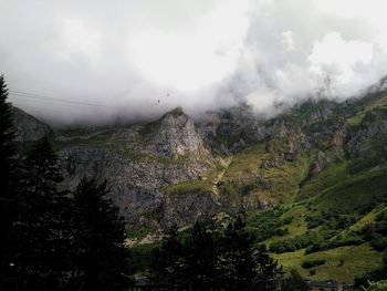 Scenic view of mountains against cloudy sky