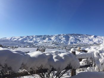Snowcapped mountains against clear blue sky
