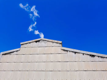 Low angle view of building against blue sky