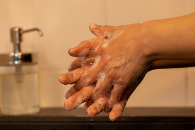 Midsection of person in bathroom at home