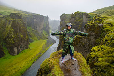 Portrait of man standing on mountain against sky