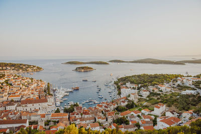 High angle view of townscape by sea against sky