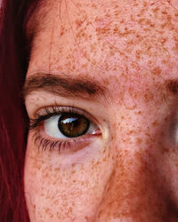 Close-up portrait of woman with freckles on face