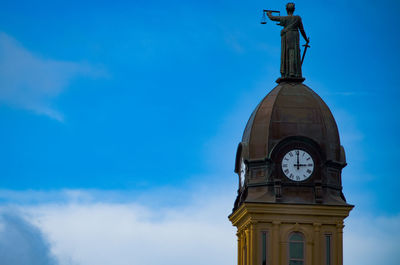 Low angle view of clock tower against sky