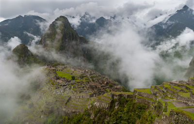 Scenic view of mountains against cloudy sky