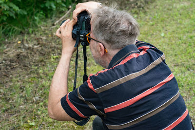 Man holding camera on field