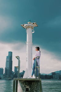 Man standing by tower against sky