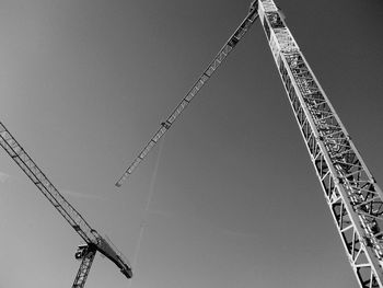 Low angle view of crane against clear sky