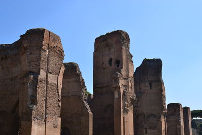 Low angle view of old ruins against blue sky