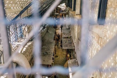 People seen through metal railing