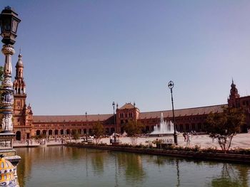 Buildings in city against clear sky