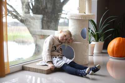 Woman sitting on table at home