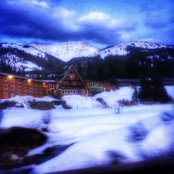 Scenic view of snow covered mountains against cloudy sky