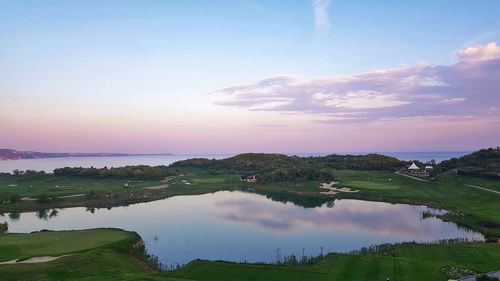 Scenic view of lake against sky during sunset