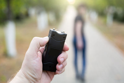 A man with a stun gun chases a woman rob.