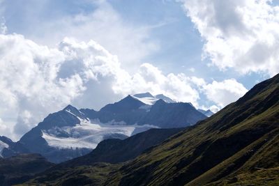 Scenic view of mountains against cloudy sky