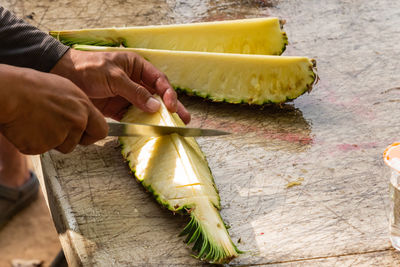 Closeup on cutting pineapple for serve as snacks on the island.