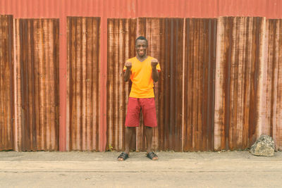 Portrait of man standing against wall