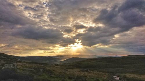 Scenic view of landscape against dramatic sky