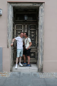 Full length of man and woman at entrance of building