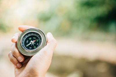 Close-up of hand holding navigational compass