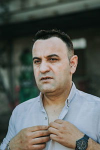 Close-up of man looking away standing outdoors