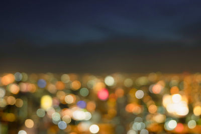 Defocused image of illuminated city at night