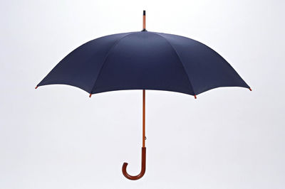 Open umbrella against white background