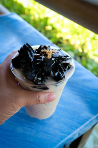 Close-up of hand holding ice cream