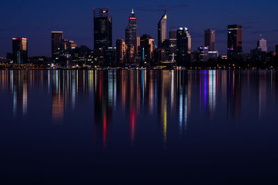 Scenic view of illuminated buildings against sky at night