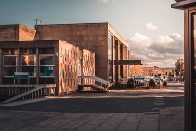 Street amidst buildings in city against sky