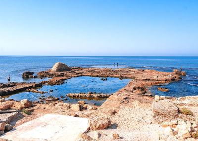 Scenic view of sea against clear blue sky