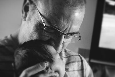 Close-up of grandfather with baby