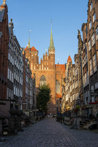 Street amidst buildings against sky in city