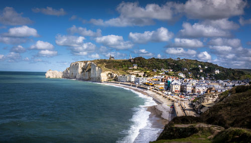 Scenic view of sea and buildings against sky