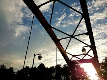 Low angle view of street light against cloudy sky