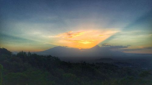 Scenic view of mountains against sky at sunset