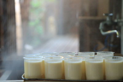 Close-up of puddings in drinking glasses on tray