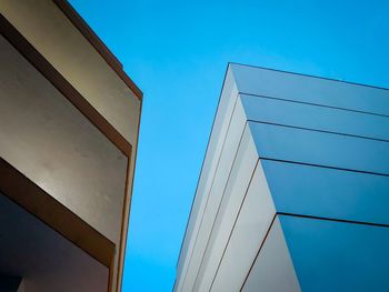 Low angle view of modern building against clear blue sky